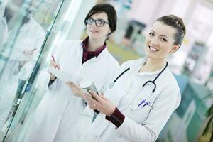 team of pharmacist chemist woman  in pharmacy drugstore photo