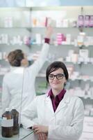 team of pharmacist chemist woman  in pharmacy drugstore photo