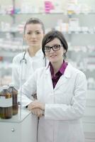 team of pharmacist chemist woman  in pharmacy drugstore photo