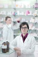 team of pharmacist chemist woman  in pharmacy drugstore photo