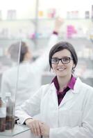 team of pharmacist chemist woman  in pharmacy drugstore photo