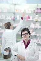 team of pharmacist chemist woman  in pharmacy drugstore photo