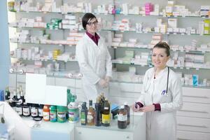 team of pharmacist chemist woman  in pharmacy drugstore photo