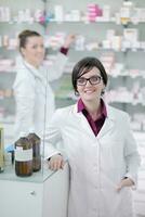 team of pharmacist chemist woman  in pharmacy drugstore photo