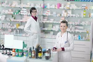 team of pharmacist chemist woman  in pharmacy drugstore photo