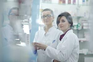 team of pharmacist chemist woman  in pharmacy drugstore photo