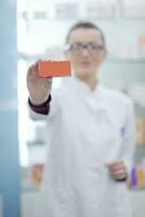 pharmacist chemist woman standing in pharmacy drugstore photo