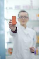 pharmacist chemist woman standing in pharmacy drugstore photo