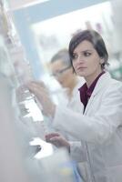 pharmacist chemist woman standing in pharmacy drugstore photo