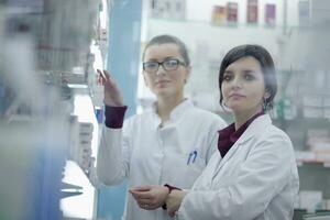 team of pharmacist chemist woman  in pharmacy drugstore photo