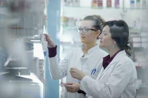 team of pharmacist chemist woman  in pharmacy drugstore photo