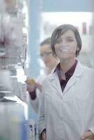 team of pharmacist chemist woman  in pharmacy drugstore photo