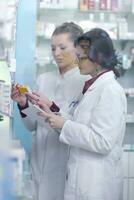 team of pharmacist chemist woman  in pharmacy drugstore photo