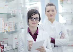 team of pharmacist chemist woman  in pharmacy drugstore photo