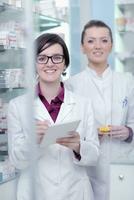 team of pharmacist chemist woman  in pharmacy drugstore photo