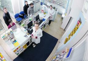 pharmacist suggesting medical drug to buyer in pharmacy drugstore photo