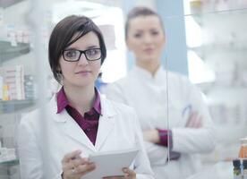 team of pharmacist chemist woman  in pharmacy drugstore photo