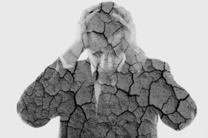 double exposure of depressed business man and dry ground background photo