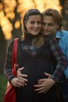 young pregnant couple have fun and relax photo