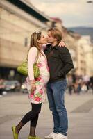 young pregnant couple have fun and relax photo