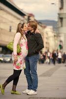 young pregnant couple have fun and relax photo