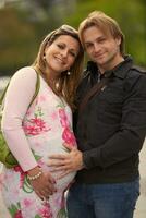 young pregnant couple have fun and relax photo