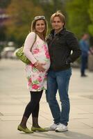 young pregnant couple have fun and relax photo