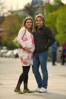 young pregnant couple have fun and relax photo