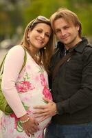 young pregnant couple have fun and relax photo