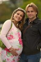 young pregnant couple have fun and relax photo