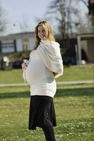 happy young pregnant woman outdoor photo