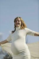 happy young pregnant woman outdoor photo