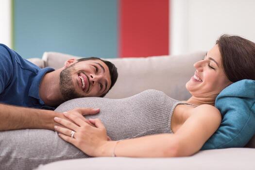 future dad listening the belly of his pregnant wife photo