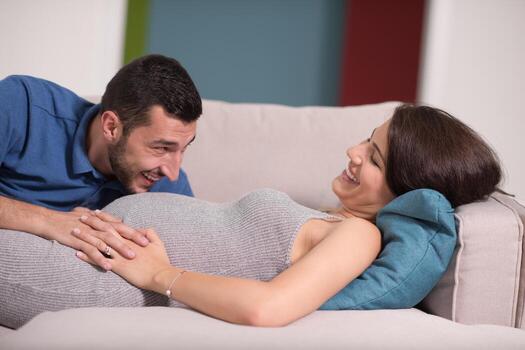 future dad listening the belly of his pregnant wife photo