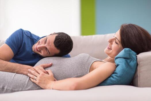 future dad listening the belly of his pregnant wife photo