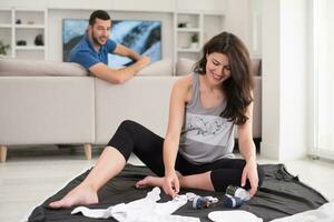 pregnant couple checking a list of things for their unborn baby photo