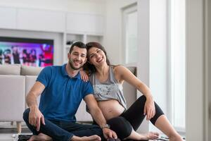 pregnant couple checking a list of things for their unborn baby photo