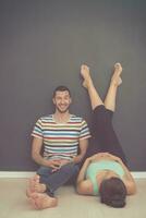 pregnant couple relaxing on the floor photo