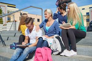 students outside sitting on steps photo