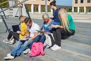 students outside sitting on steps photo