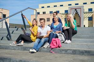 students outside sitting on steps photo