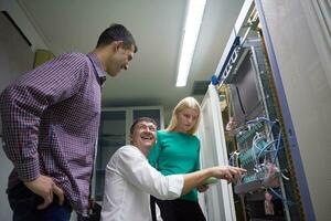 network engeneers working in network server room photo