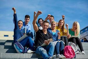 students outside sitting on steps photo