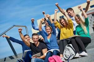 students outside sitting on steps photo