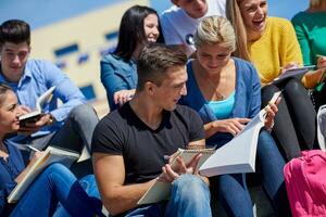 students outside sitting on steps photo