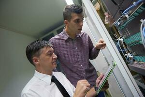 network engineers in server room photo