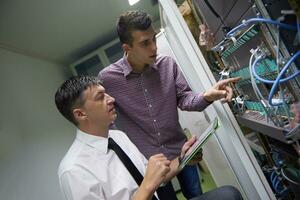 network engineers in server room photo