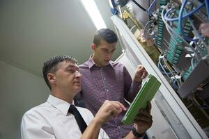 network engineers in server room photo