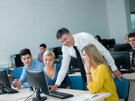 students with teacher  in computer lab classrom photo