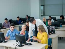 students with teacher  in computer lab classrom photo